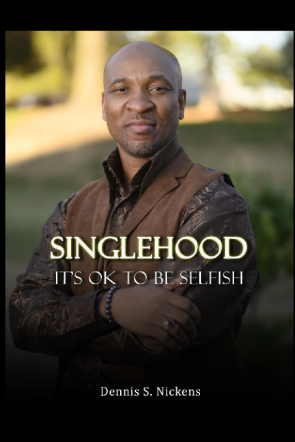 The image features the cover of the book titled "Singlehood: It's Ok To Be Selfish" by Dennis S. Nickens.
