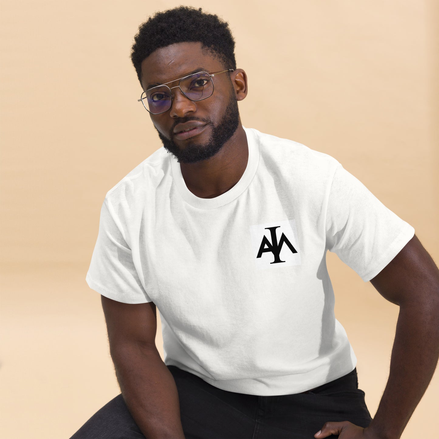 Man wearing a white t-shirt with a logo on a beige background